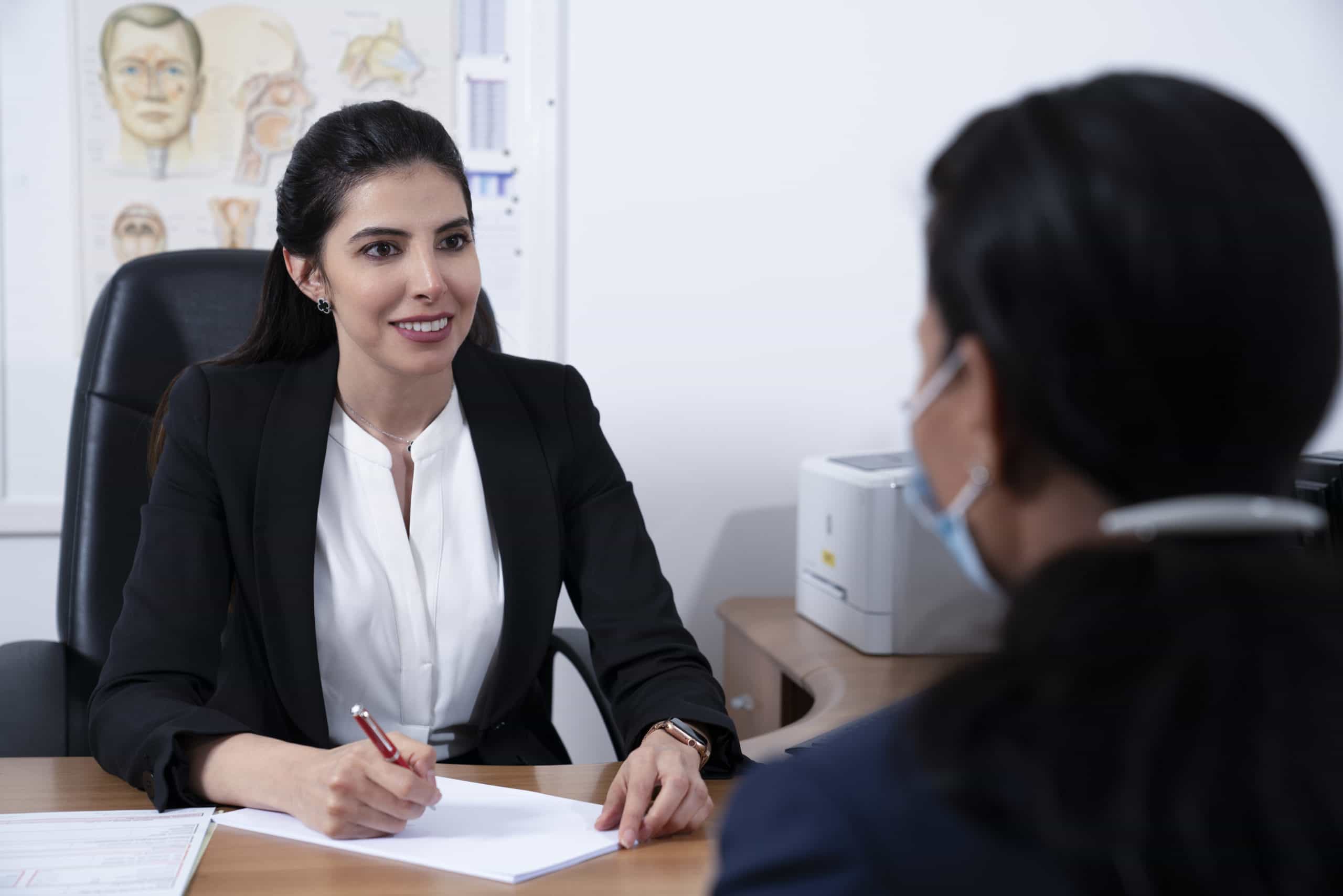 Dr Hiba in consultation with a patient